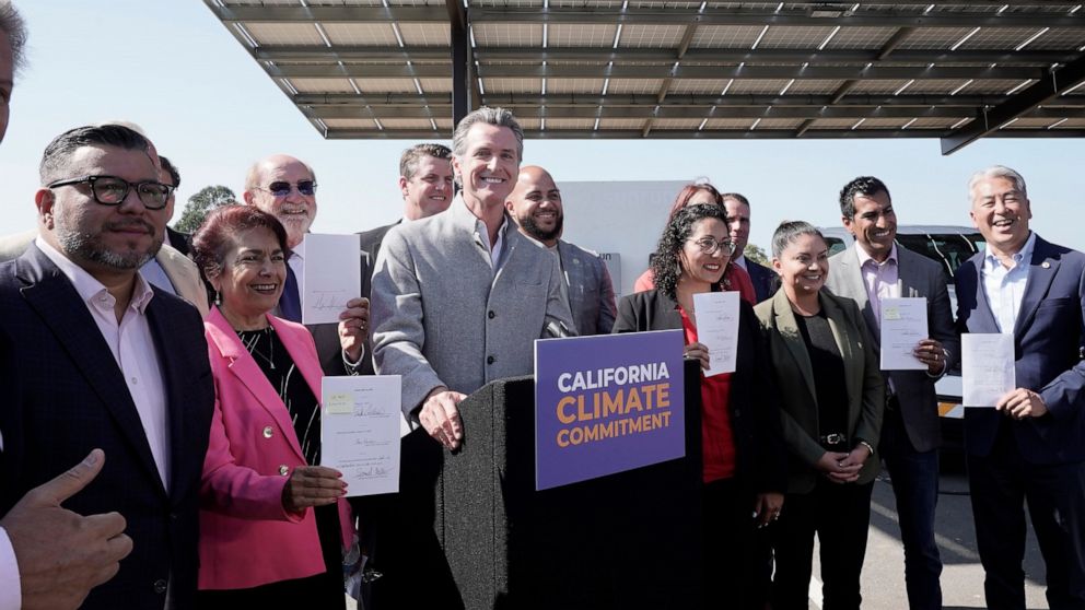 Gov. Gavin Newsom, center, poses with lawmakers after signing a package of legislation that accelerates the climate goals of the nation's most populous state at Mare Island in Vallejo, Calif., Friday, Sept. 16, 2022. (AP Photo/Rich Pedroncelli)