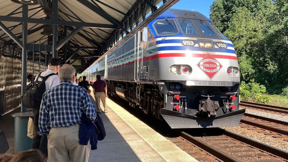 Commuters wait to board an arriving Virginia Railway Express commuter train Wednesday, Sept. 14, 2022 at the Crystal City station in Arlington, Va. September was shaping up as a good month for commuters on Virginia Railway Express outside the nation'