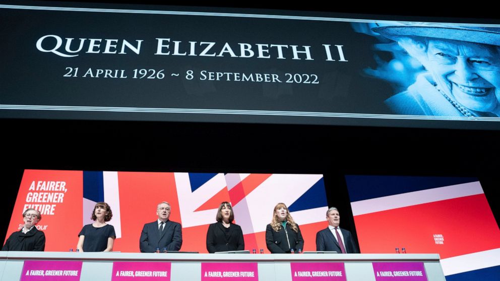 Labour party leader Keir Starmer, right, leads tributes to Queen Elizabeth II as the national anthem is sung during the Labour Party Conference in Liverpool, Sunday Sept. 25, 2022. Britain’s opposition Labour Party opened its annual conference Sunday